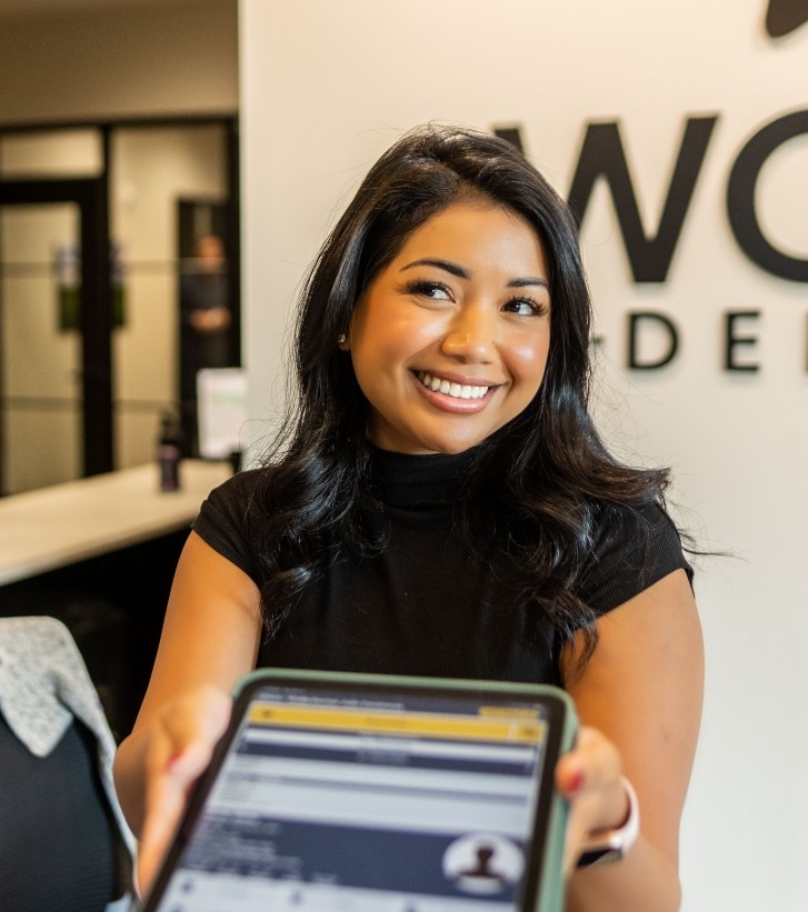 Smiling woman leaning back in dental chair