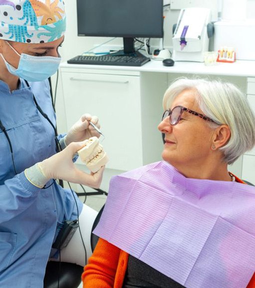 Senior patient talking to dental team member during consultation