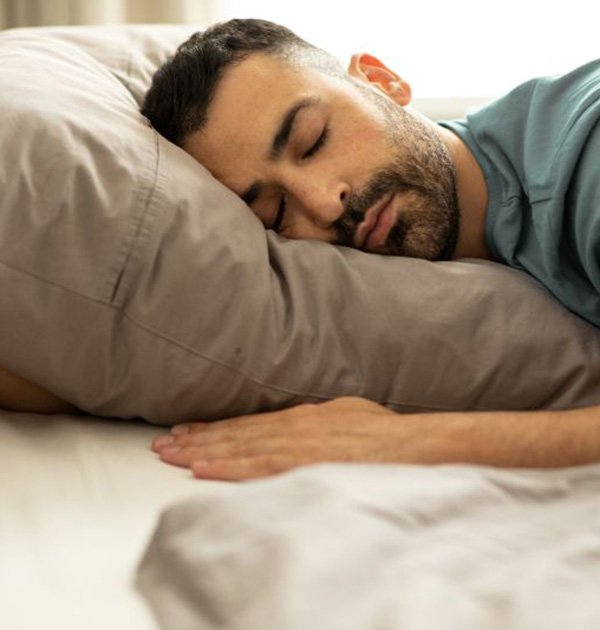 Man sleeping peacefully in bed