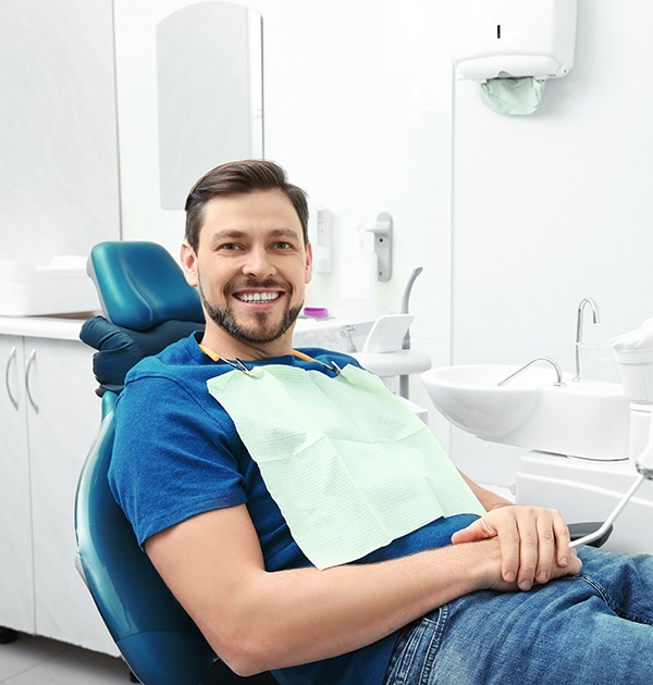 Male dental patient smiling in dental chair