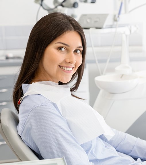 Female dental patient looking to side and smiling