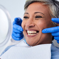 woman smiling at reflection in mirror