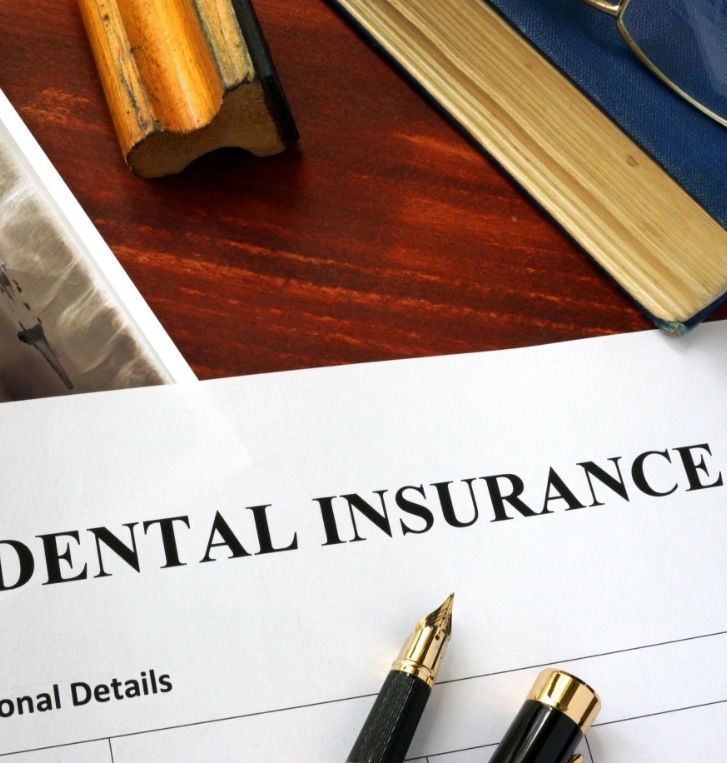 Paperwork on desk for dental insurance in Beaverton