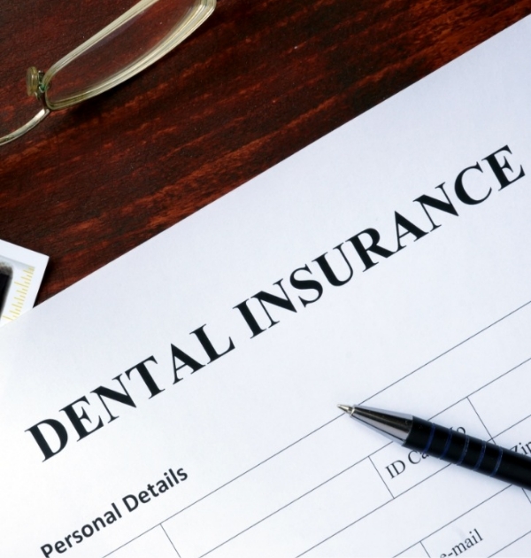 Paperwork on desk for dental insurance in Beaverton