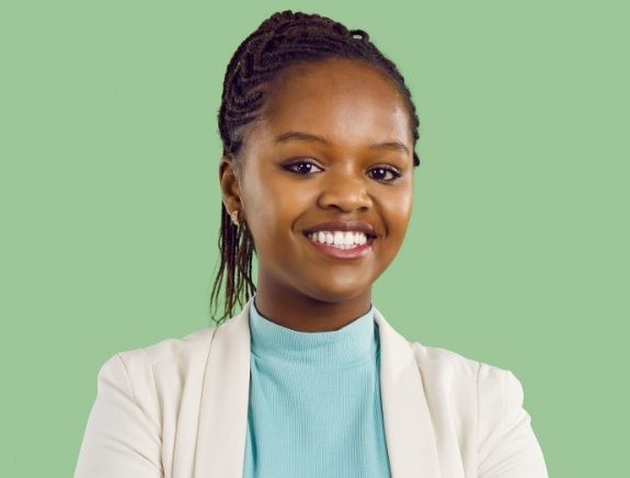 Woman smiling against green background