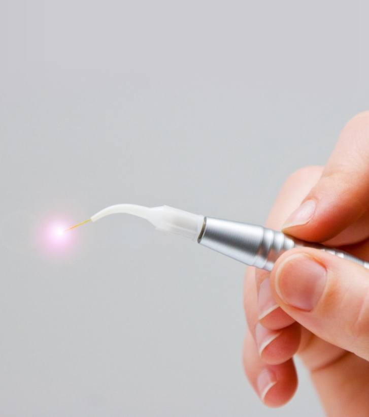 Hand holding a thin dental laser device