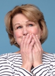 Senior woman covering her mouth with both hands