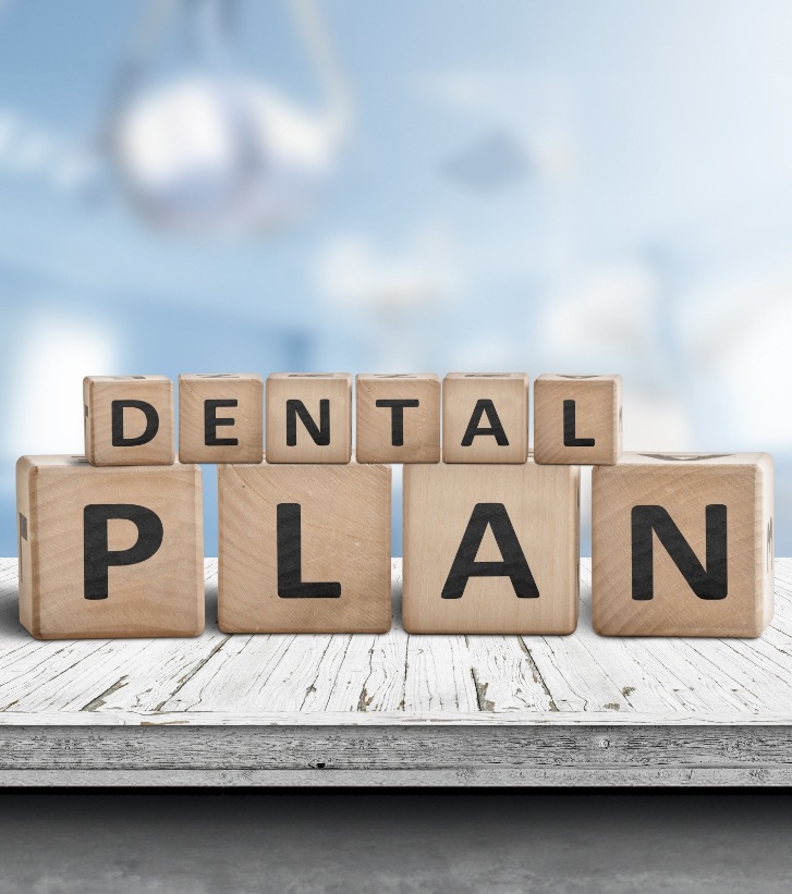 Wooden block letters spelling out the words dental plan
