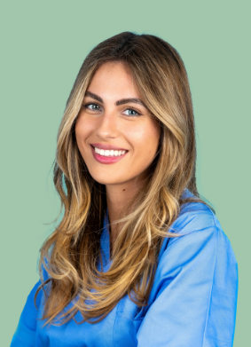 Woman in blue blouse smiling with eyes open