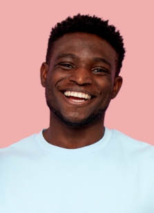Man in light blue sweater grinning