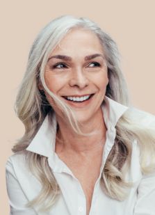 Woman with long gray hair smiling