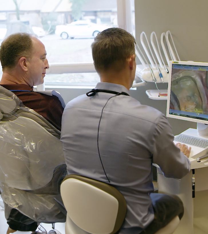 Beaverton dentist showing a patient a photo of their tooth