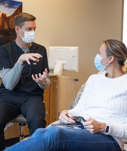 member of dental staff smiling with patient