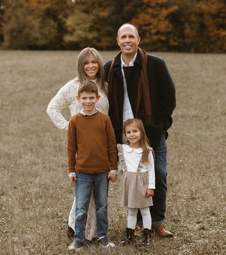 Doctor Yesenofski with his wife and two children outdoors