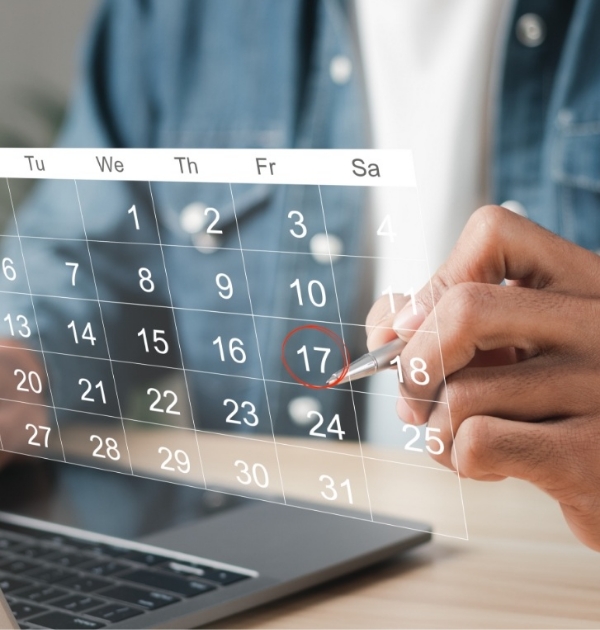 Person circling a date on a holographic calendar