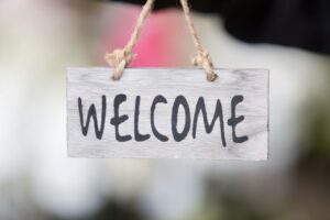 Cheerful welcome sign against blurred background