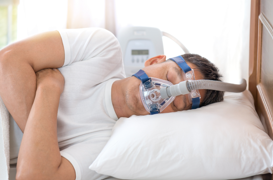 Man with CPAP machine sleeping