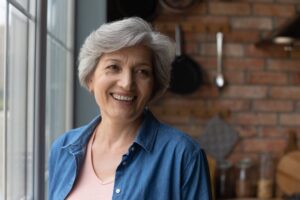 Woman with All-of-X dental implants smiling